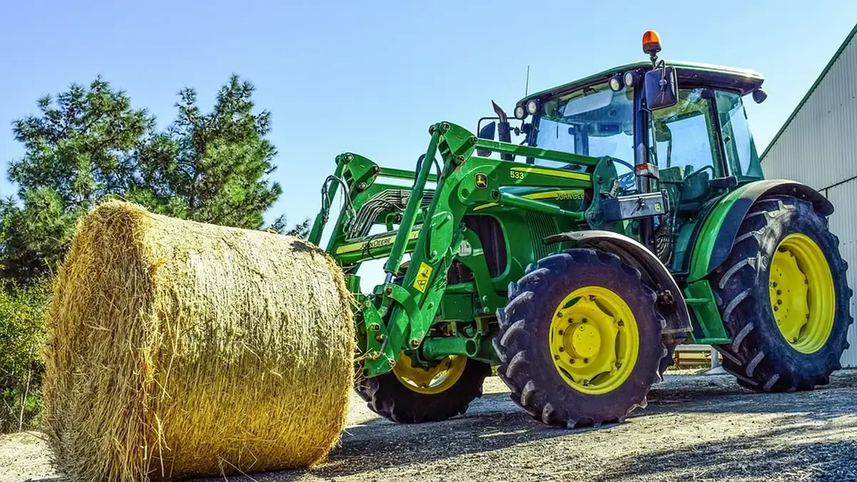 Tractor with three-point linkage and remote hydraulic couplers in a field