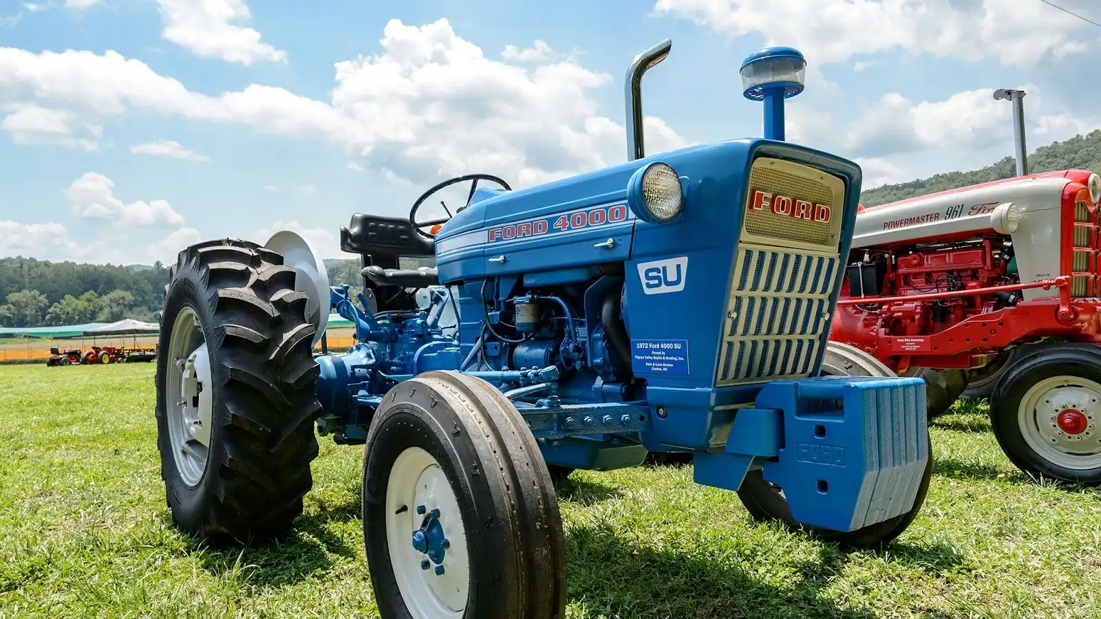 Green tractor with rear hydraulic outlets and implement couplers