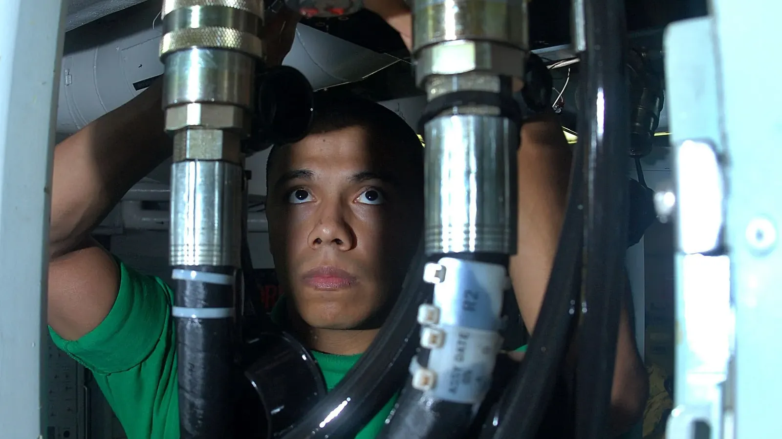 Technician adjusting a connection point on a hydraulic test station