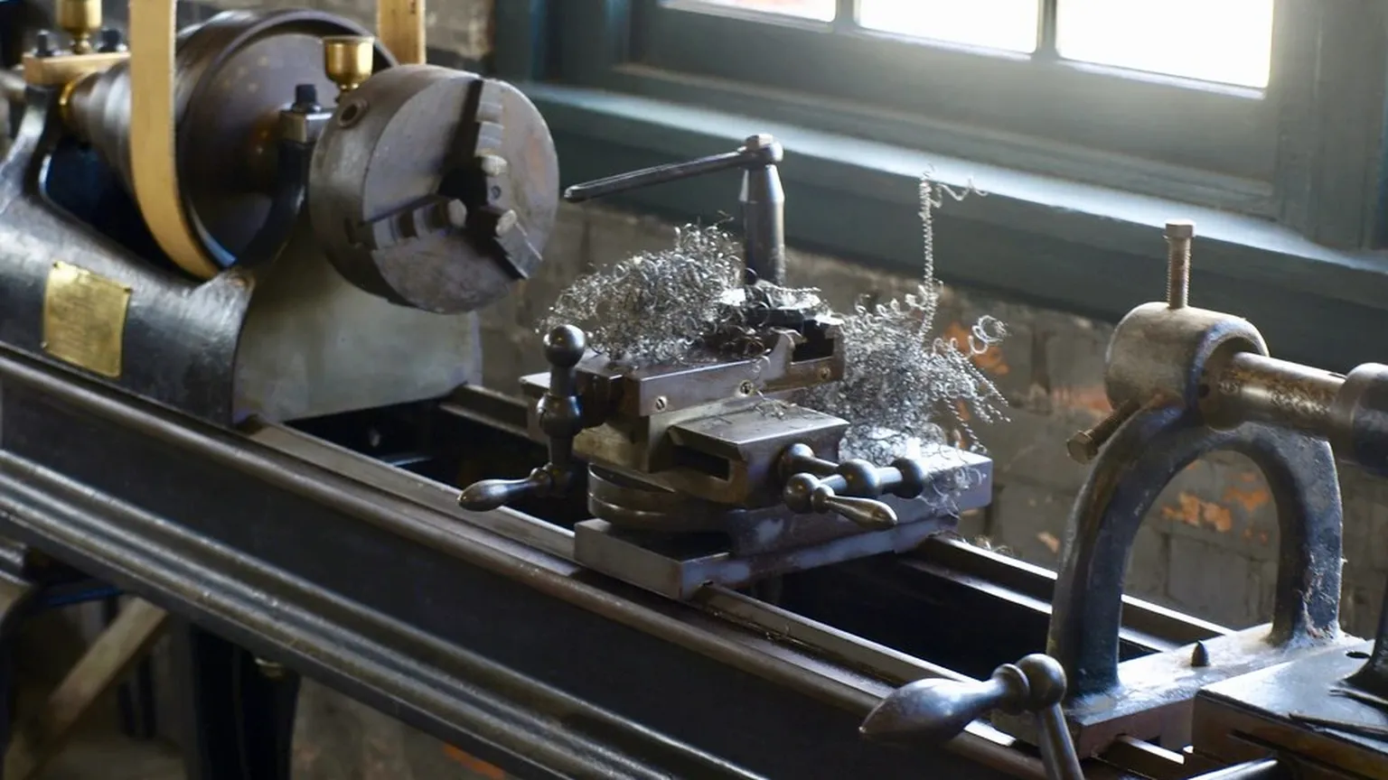 Metal lathe turning a steel coupling body